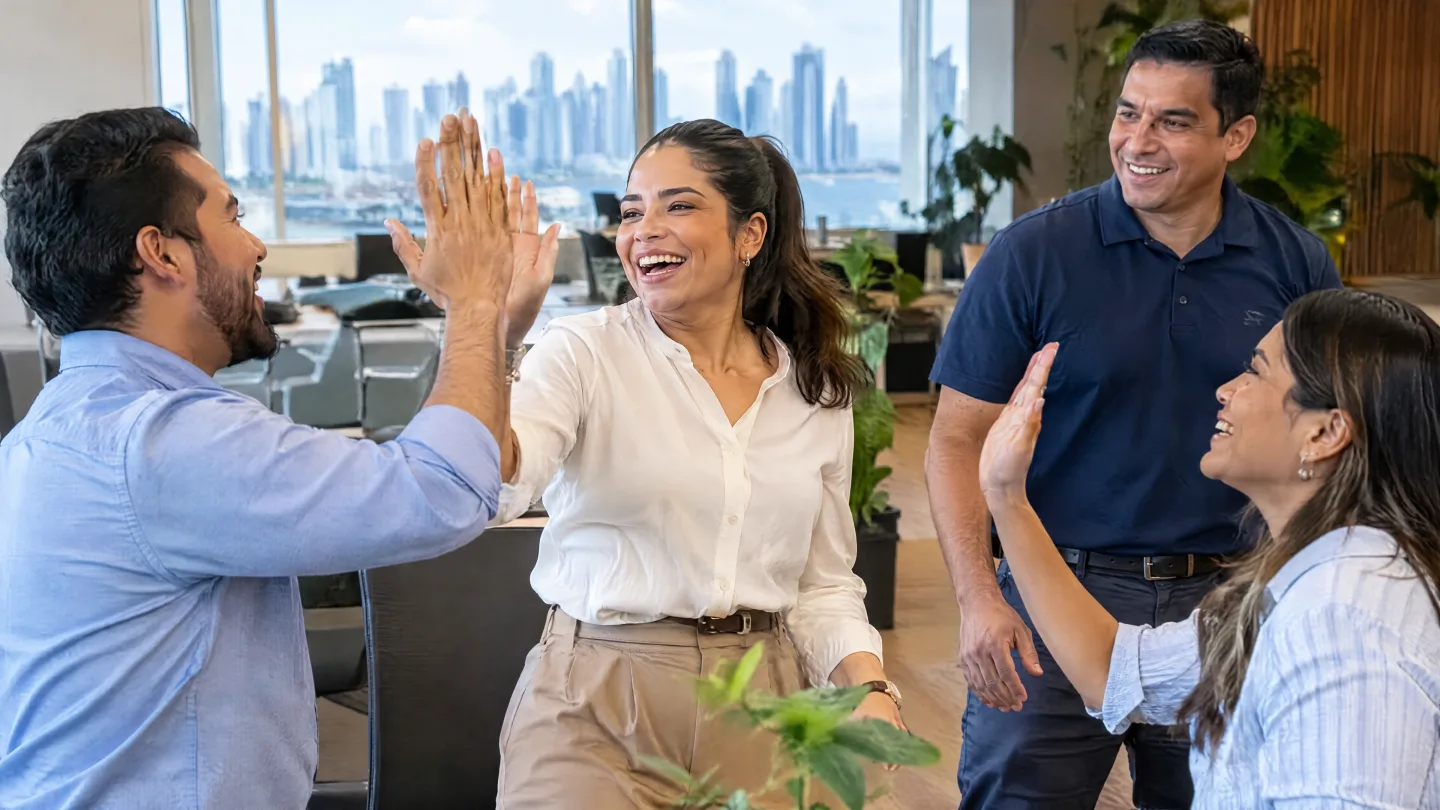 Employees high-five and smile after an active break at the office