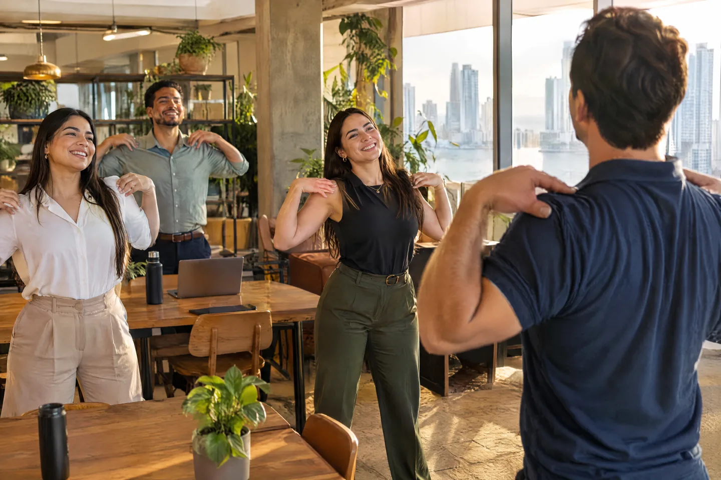 Coworking team doing shoulder stretches with a THA instructor