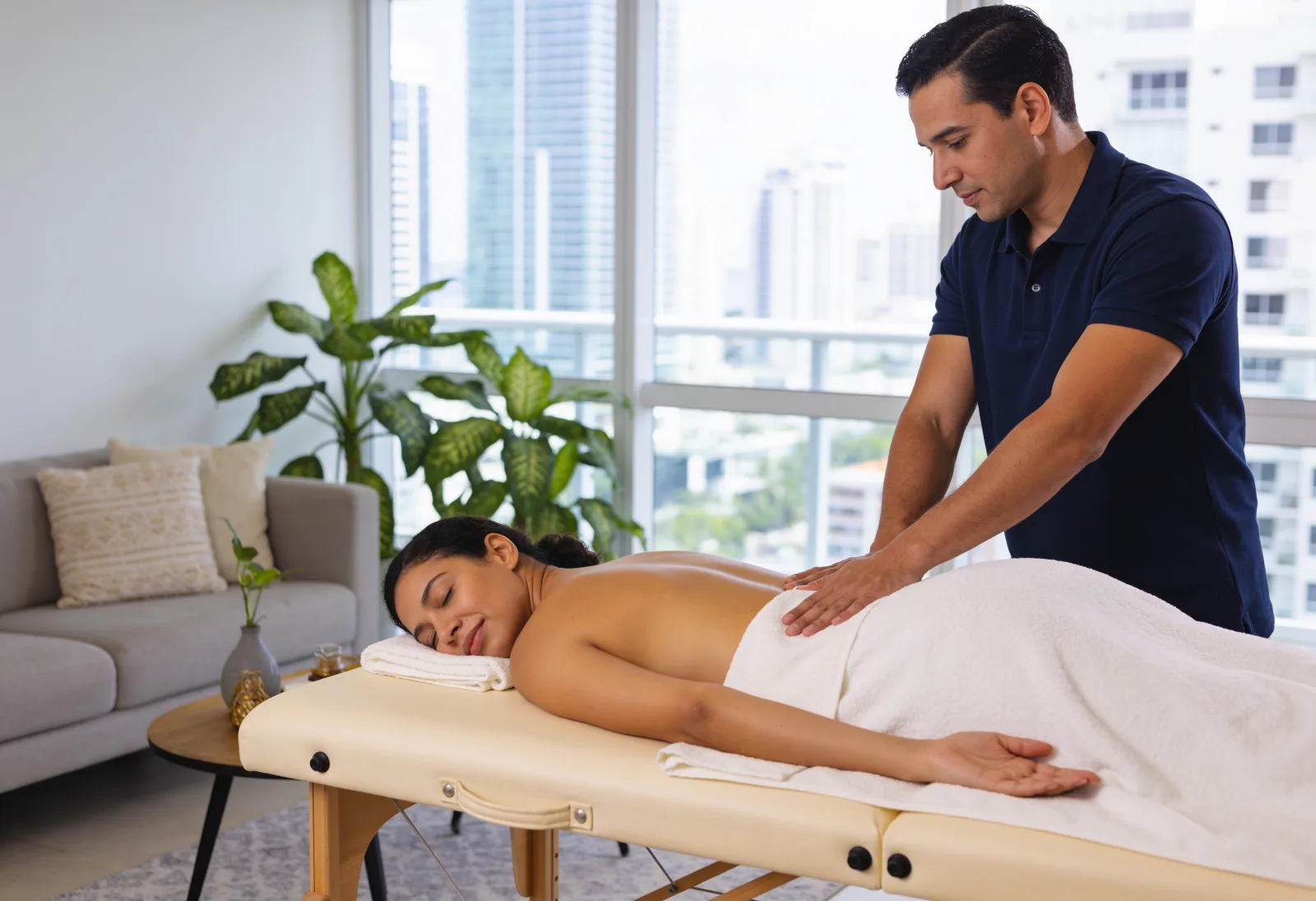 Relaxed client receiving a massage on her table at home
