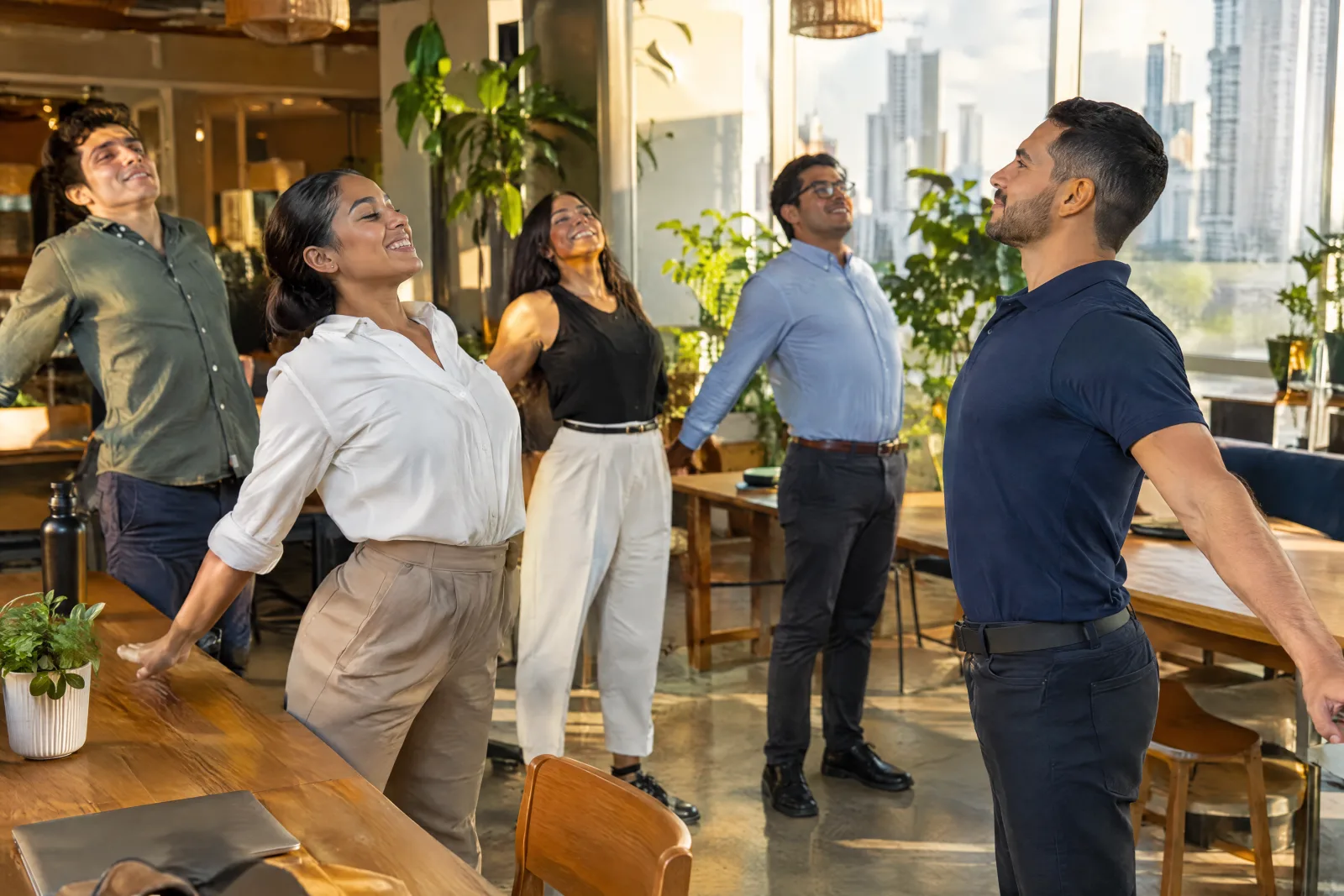THA instructor leading an active break with a team in a coworking space