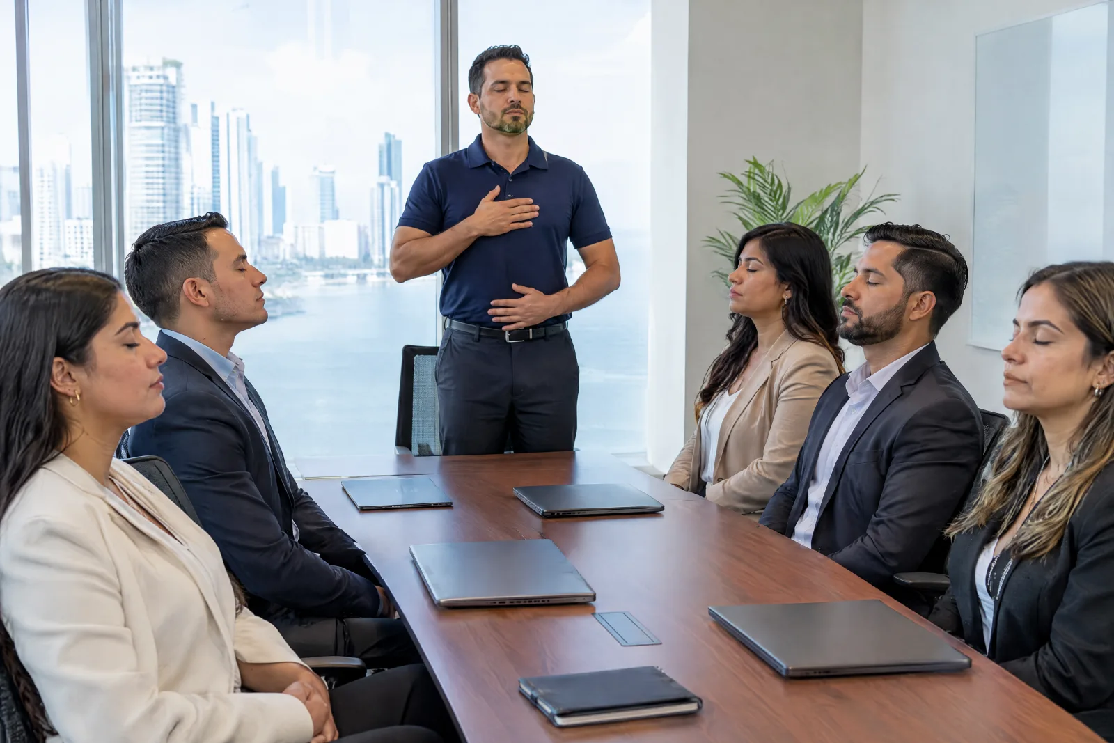 THA instructor guiding breathing with a group in a meeting room
