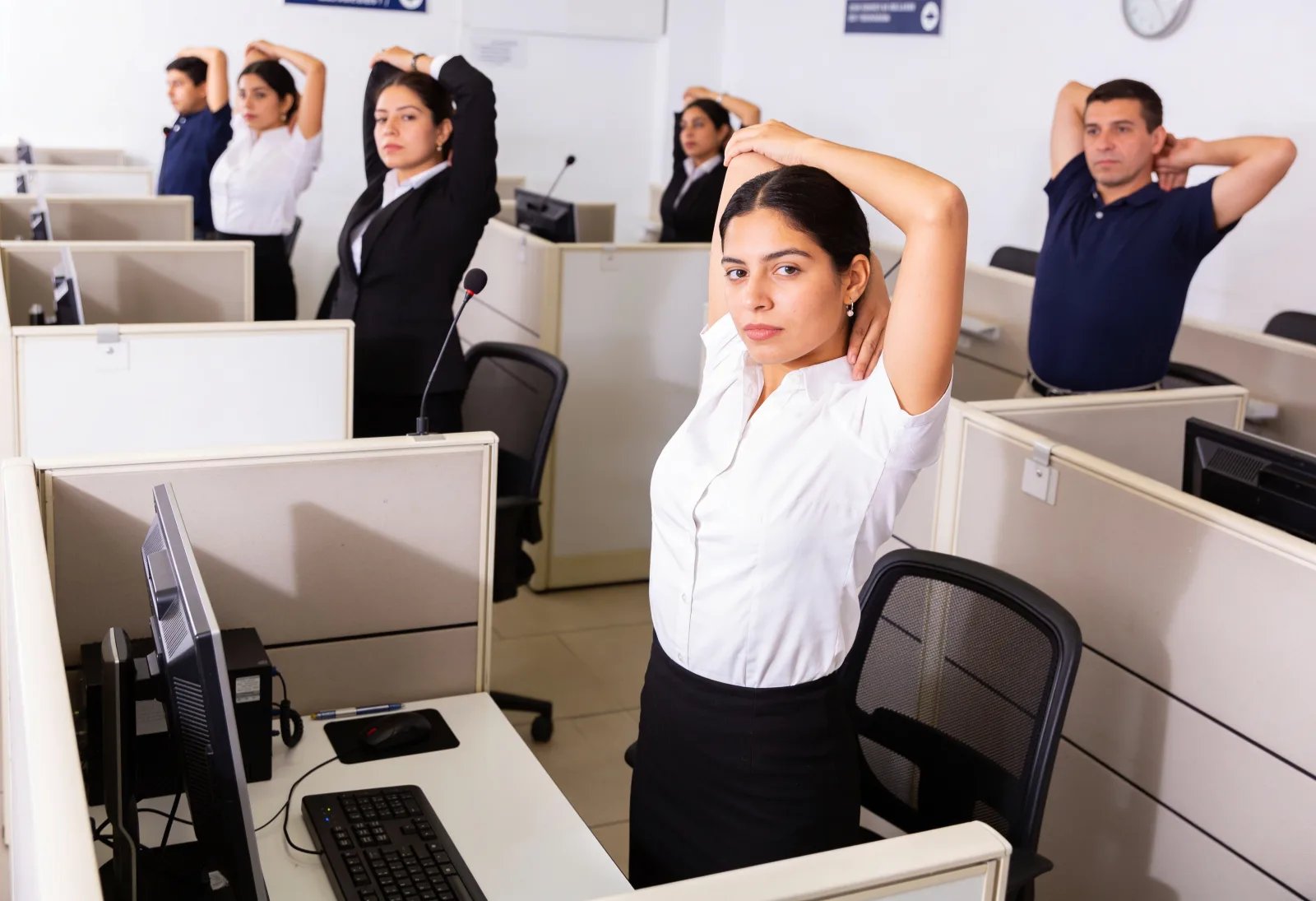 Public employees stretching neck and arms in a government office