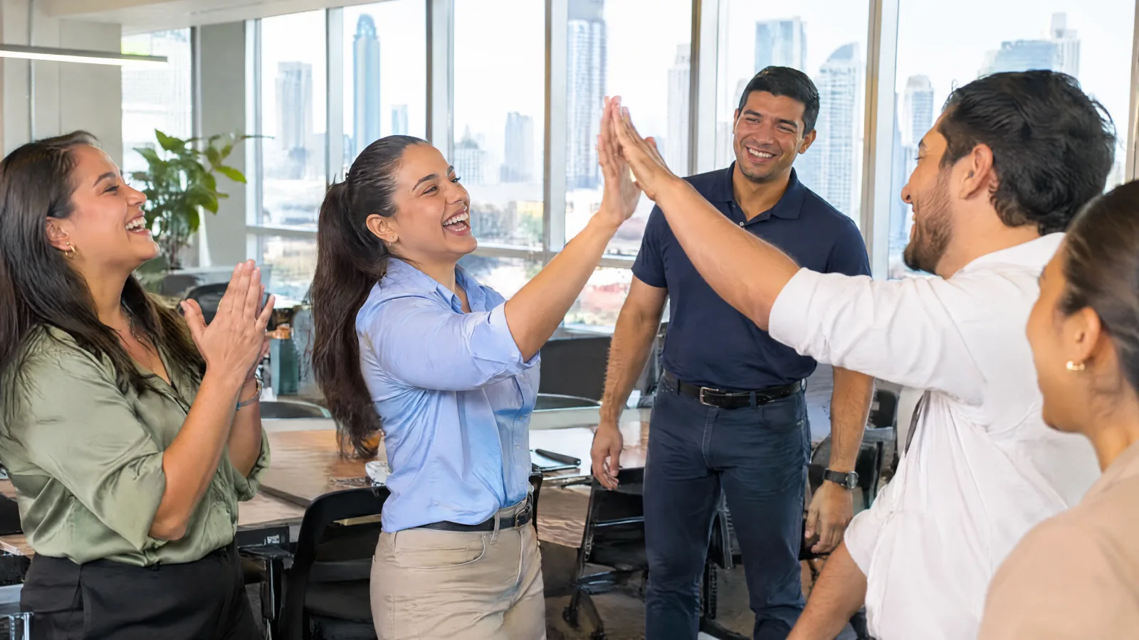 Employees celebrating with a high five after an active break