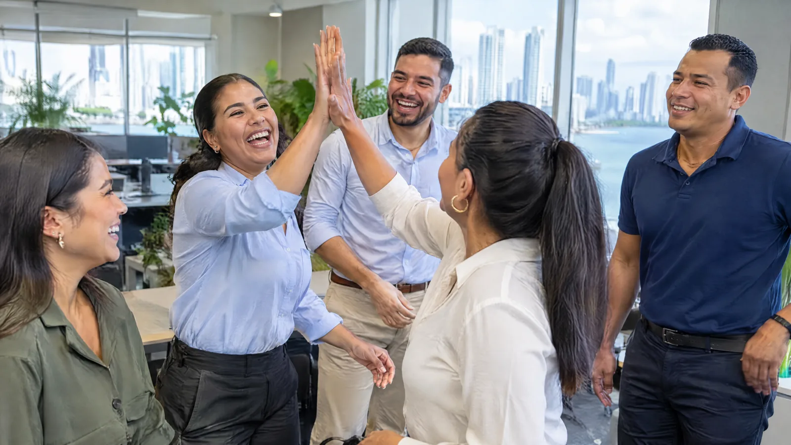 Office team high-fiving after an active break