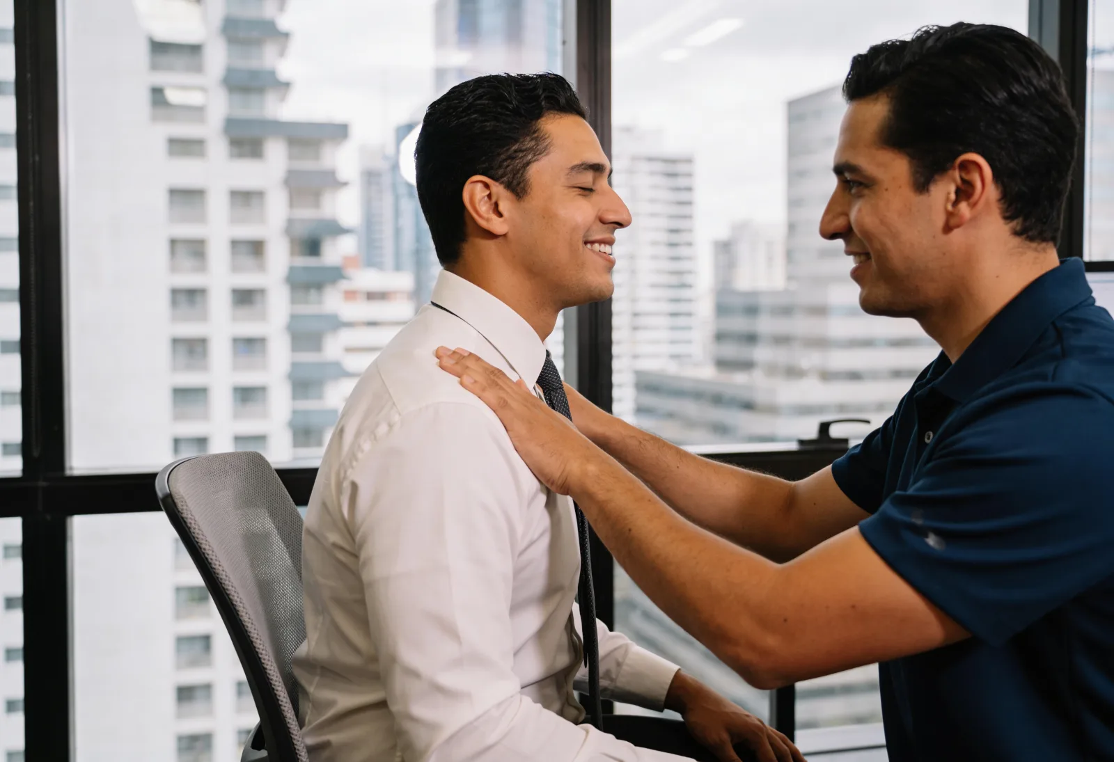 Bank employee smiling during a seated shoulder massage
